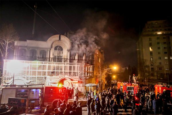 Smoke rises as Iranian protesters set fire to the Saudi embassy in Tehran Sunday Jan. 3 2016. Protesters upset over the execution of a Shiite cleric in Saudi Arabia set fires to the Saudi embassy in Tehran