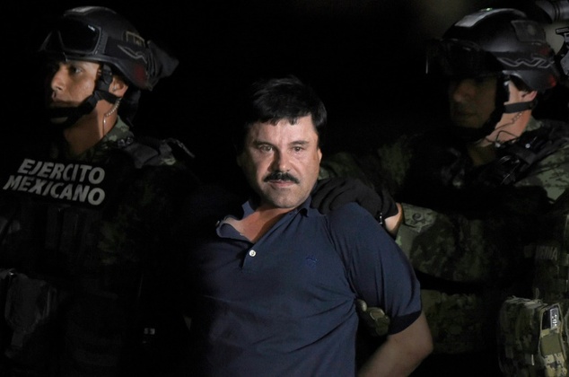 Drug kingpin Joaquin'El Chapo Guzman is escorted into a helicopter at Mexico City's airport