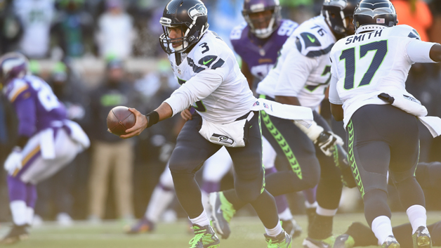 MINNEAPOLIS MN- JANUARY 10 Russell Wilson #3 of the Seattle Seahawks hands the ball off in the second half against the Minnesota Vikings during the NFC Wild Card Playoff game at TCFBank Stadium