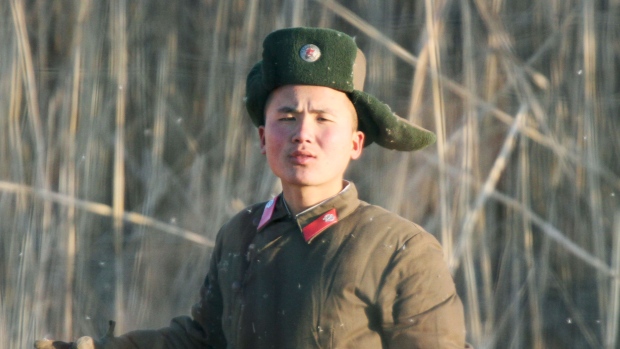 A North Korean soldier is seen near the North Korean town of Sinuiju as seen from the opposite Chinese border city of Dandong on Wedfnesday. North Korea said it successfully tested a miniaturised hydrogen nuclear bomb setting off alarm bells in Japan