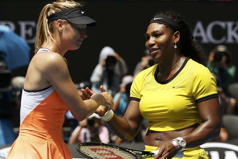 Russia's Maria Sharapova reacts as she shakes hands with Serena Williams