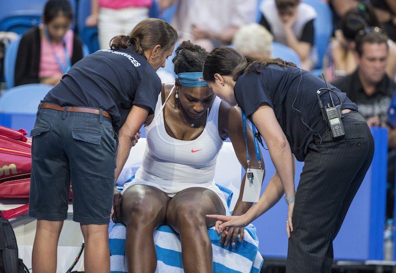 Serena Williams of the US speaks to medical staff before withdrawing from the women's match between the US and an Australian team at the Hopman Cup in Perth Australia today. – Reuters pic