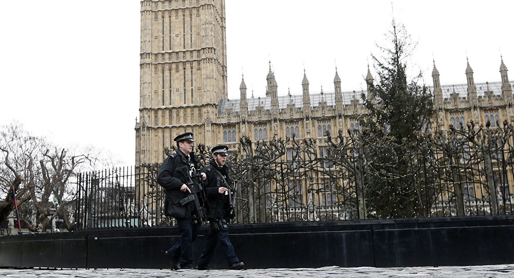 Armed police are seen on patrol at The Houses of Parliament in London England