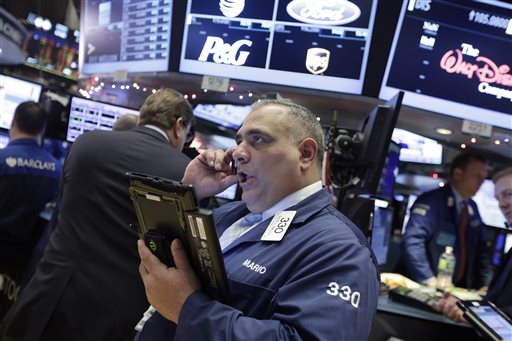 Trader Mario Innella works on the floor of the New York Stock Exchange Monday Jan. 4 2016. U.S. stocks are opening 2016 on a grim note dropping sharply after a plunge in China and declines in Europe. AP