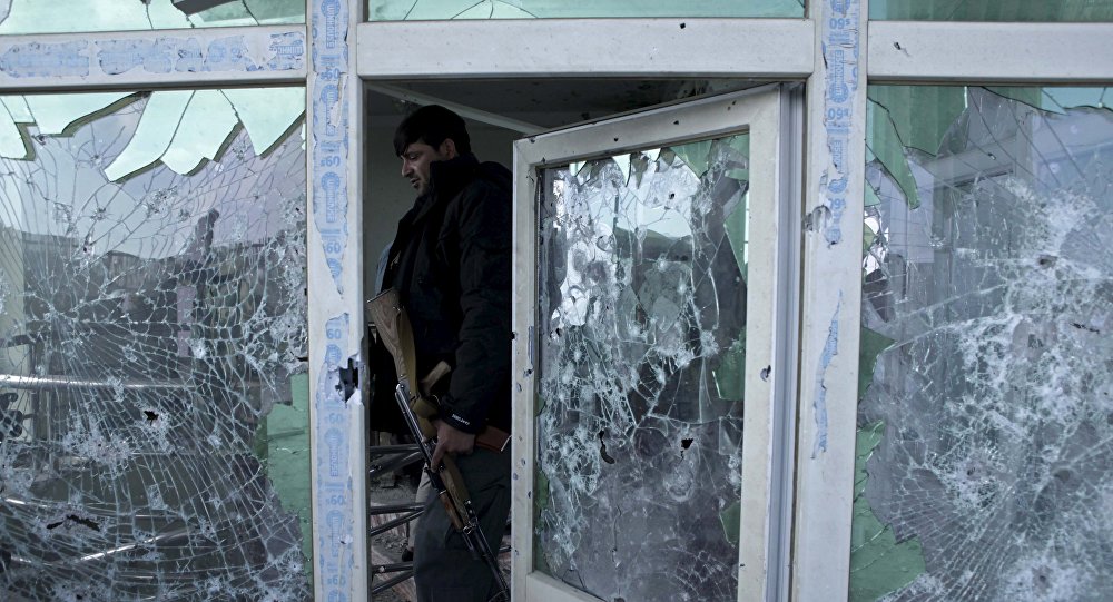 An Afghan policeman inspects a building used by insurgents after an operation near the Indian consulate in Mazar-i-Sharif Afghanistan