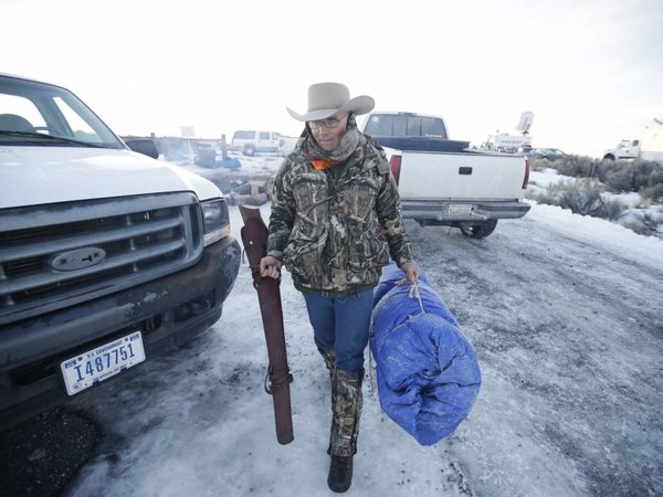 Arizona rancher La Voy Finicum carries his rifle after standing guard all night at the Malheur National Wildlife Refuge Wednesday Jan. 6 2016 near Burns Ore. With the takeover entering its fourth day Wednesday authorities had not removed the group