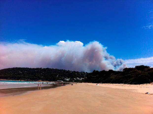 Smoke rises from a fast-moving bushfire near the Great Ocean Road in Victoria Australia