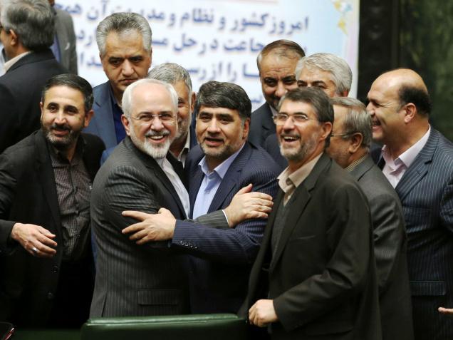 Iranian Foreign Minister Mohammad Javad Zarif second left who is also Iran's top nuclear negotiator is surrounded by a group of lawmakers in an open session of parliament in Tehran on Sunday