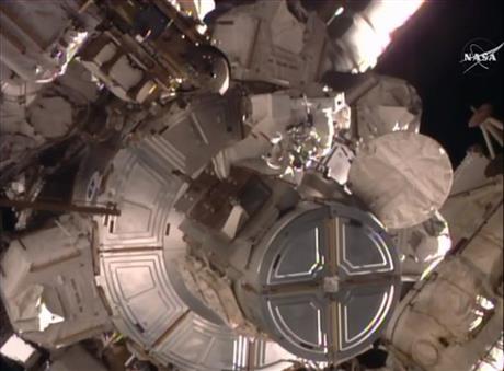 In this frame grab from video provided by NASA-TV U.S. astronaut Timothy Kopra emerges from the International Space Station Friday Jan. 15 2016. Kopra and British spaceman Timothy Peake are working to restore full power to the International Space Stat