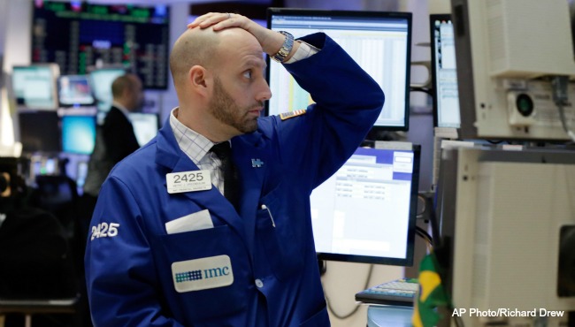 Specialist Meric Greenbaum works on the floor of the New York Stock Exchange as stocks plunge Monday Jan. 4 2016