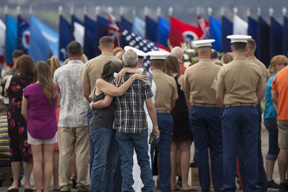 Family members embrace at a memorial for the Marines who died when their helicopters crashed