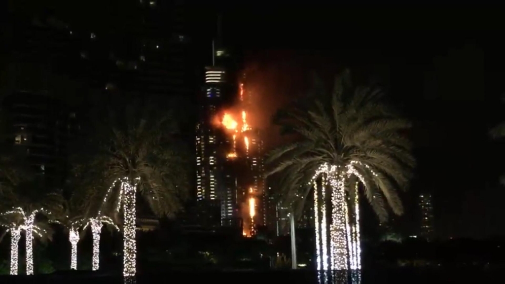 This image taken from AP video shows smoke and flames pouring from a residential building which also contains the Address Downtown Hotel in Dubai United Arab Emirates Thursday evening Dec. 31 2015