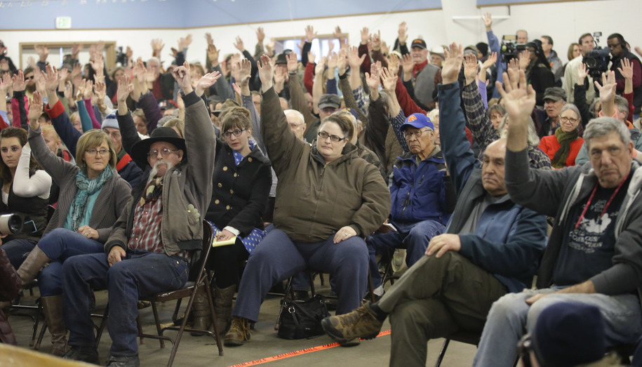 Residents raise their hands as Harney County Sheriff David Ward addresses their concerns at a community meeting at the Harney County fairgrounds Wednesday Jan. 6 2016 in Burns Ore. With the takeover entering its fourth day Wednesday authorities had