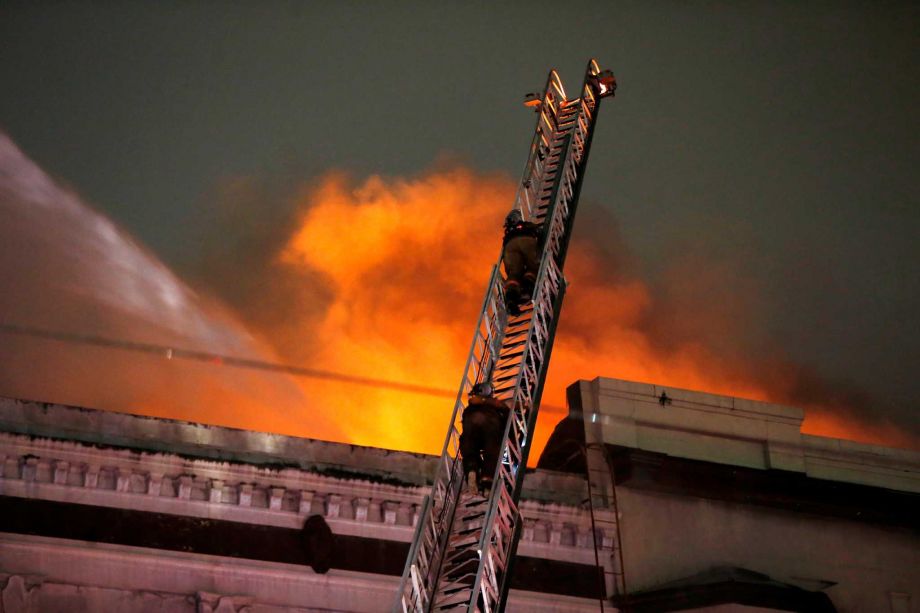 Firefighters battle a fire on Canal Street in downtown New Orleans Wednesday Jan. 27 2016