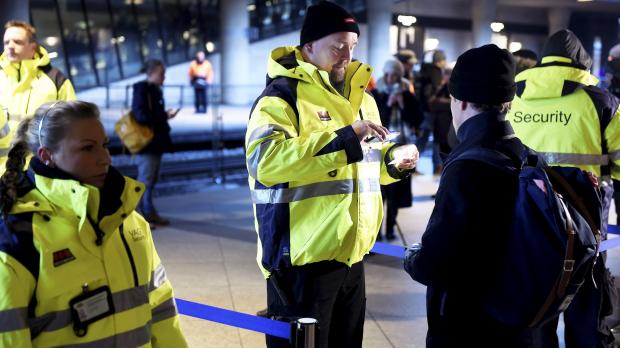 Security staff check people's identification at Kastrups train station outside Copenhagen