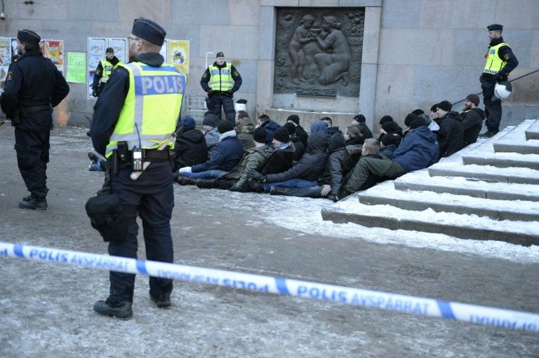 Swedish police surrounds an arrested group of neo Nazis that staged an unannounced rally in Stockholm following a brawl