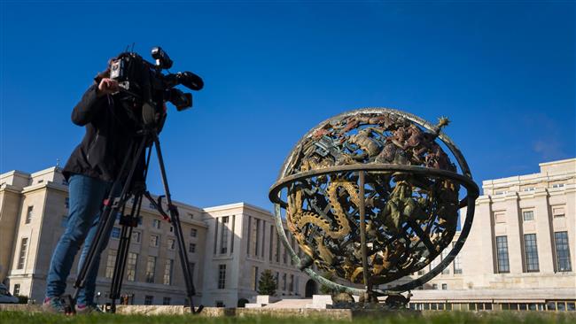 A camerawoman films the Globe outside of the United Nations Offices on the opening day of peace talks on Syria