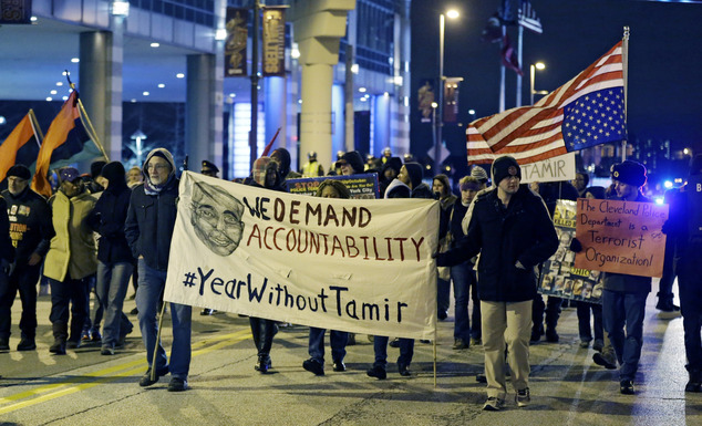 People protest a grand jury's decision not to indict two white Cleveland police officers in the fatal shooting of Tamir Rice a black 12-year-old boy who was