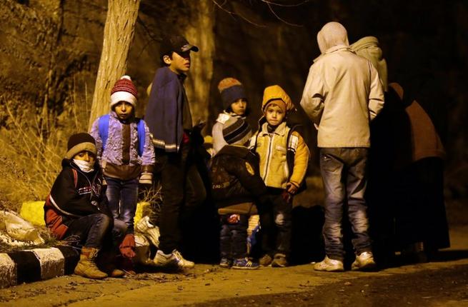 Syrian children wait on the outskirts of the besieged rebel-held Syrian town of Madaya