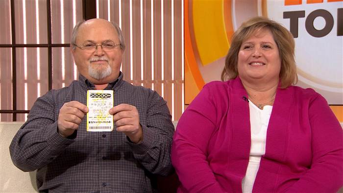 John and Lisa Robinson of Munford Tennessee show off what they claim is one of the three winning Powerball tickets from the largest jackpot in history. Source TODAY