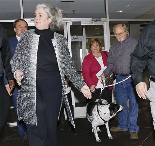 John Robinson right arrives at the Tennessee Lottery headquarters with his wife Lisa center and family dog as Rebecca Hargrove front left president and CEO of the Tennessee Lottery greets them Friday Jan. 15 2016 in Nashville Tenn. The Robinso