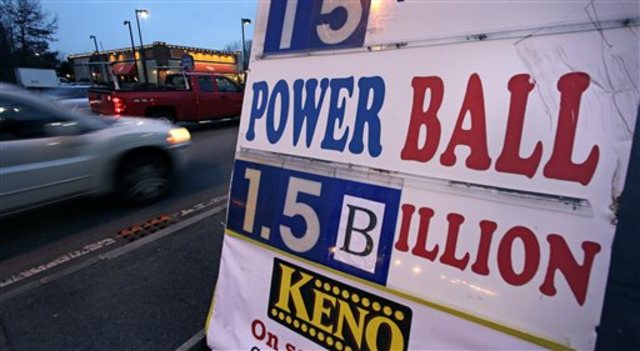 Balbir Atwal the owner of a 7 Eleven store that sold a winning Powerball lottery ticket holds up a Millionaire Made Here sign at his store in Chino Hills Calif. Thursday