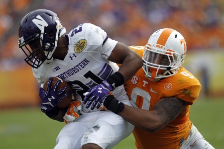 Jan 1 2016 Tampa FL USA Northwestern Wildcats running back Justin Jackson runs the ball against Tennessee Volunteers defensive back Derek Barnett in the second half at the 2016 Outback Bowl at Raymond James Stadium. Tennessee defeated Northw