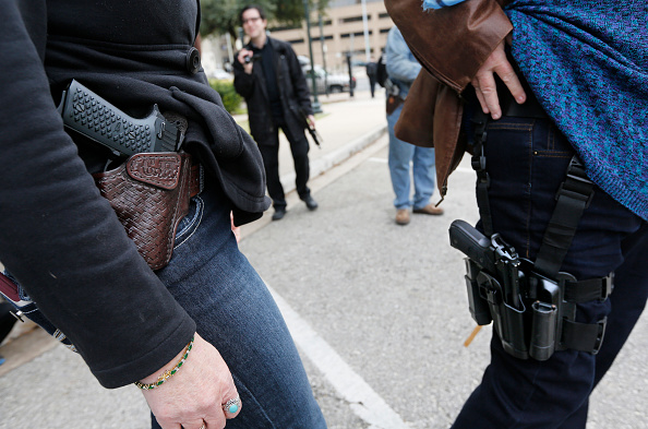 AUSTIN TX- JANUARY 1 Two women compare handgun holsters during an open carry rally at the Texas State Capitol in Austin Texas. On