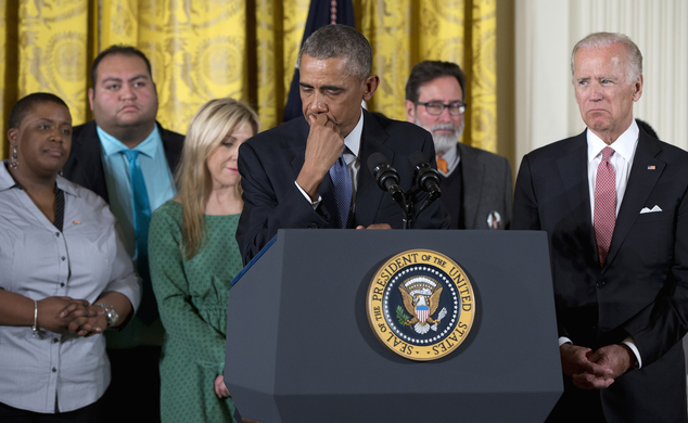 President Barack Obama joined by Vice President Joe Biden and gun violence victims pauses as he speaks in the East Room of the White House in Washington T