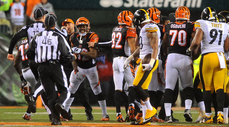 The Cincinnati Bengals and the Pittsburgh Steelers are sperated by officials during the AFC Wild Card playoff game