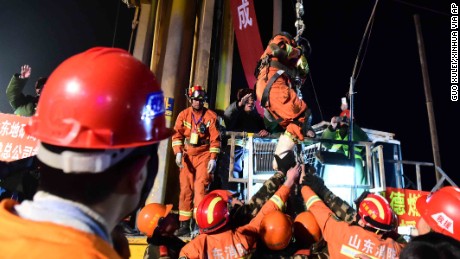 The first miner is lifted from a collapsed mine in Pingyi County China on Friday night