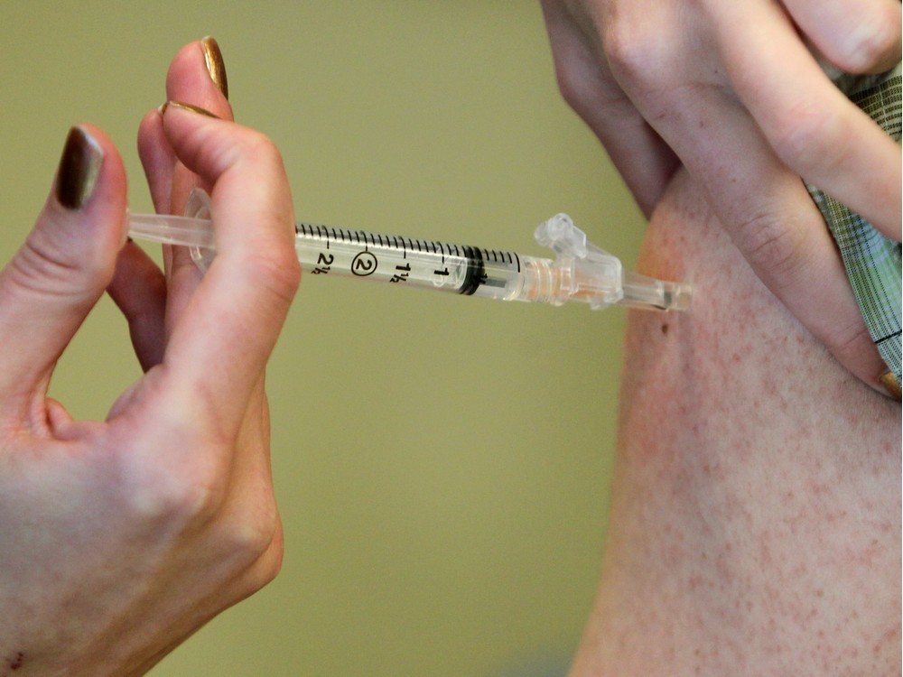 The flu vaccine is administered at an Alberta Health Services immunization clinic in Sundance