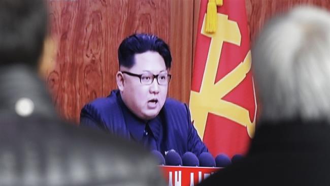 The image shows North Korea leader Kim Jong-un delivering a New Year address