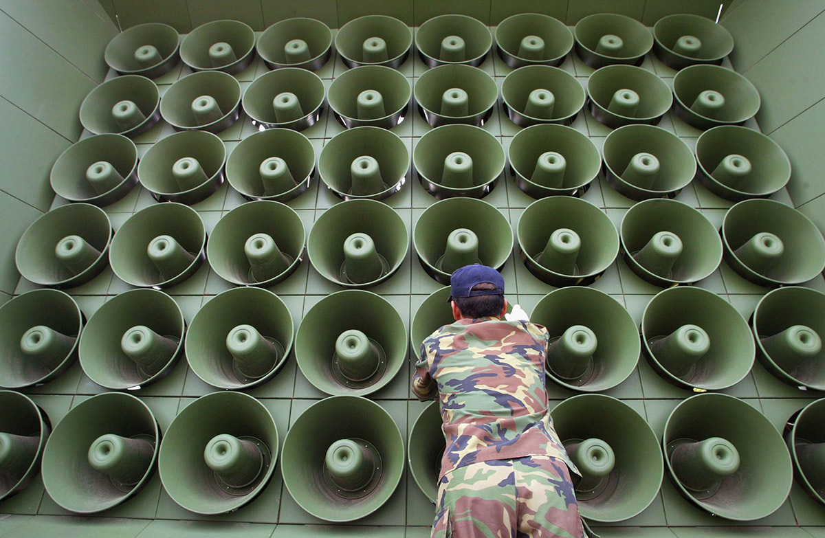 PAJU REPUBLIC OF KOREA- JUNE 16 A South Korean soldier takes down a battery of propaganda loudspeakers on the border with North Korea in Paju on 16 June 2004 in Paju South Korea. The removal of the propaganda devices along the world?s last Cold War