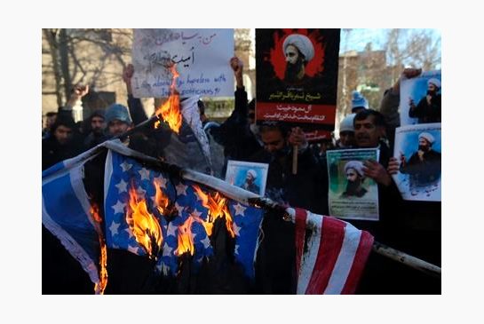 Iranian demonstrators burn representations of the U.S. and Israeli flags during a demonstration in front of the Saudi Arabian Embassy in Tehran Iran. Diplomatic tensions between Saudi Arabia and Iran whic