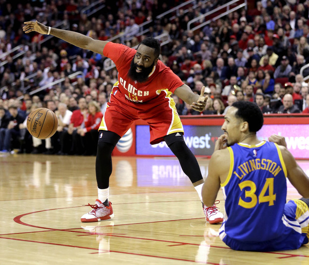 Houston Rockets James Harden loses the ball as Golden State Warriors Shaun Livingston falls to the floor during the second half of an NBA basketb