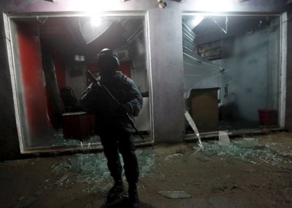 An Afghan policeman stands guard at the site of an explosion in Kabul Afghanistan in this