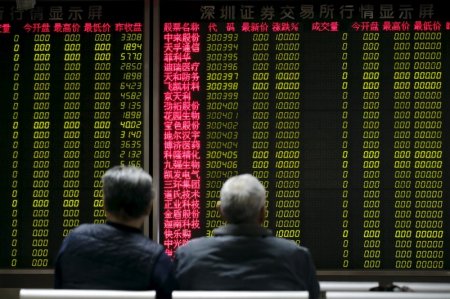 Investors wait for China's stock market to open in front of an electronic board at a brokerage house in Beijing China