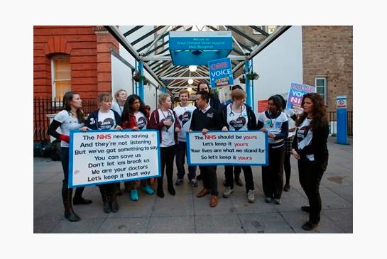 The British National Heath Service Singers who are either doctors or nurses perform a protest song in support of junior doctors outside Great Ormond Street Hospital for Sick Children as a 24-hour junior doctor strike starts in London Tuesday Jan. 12