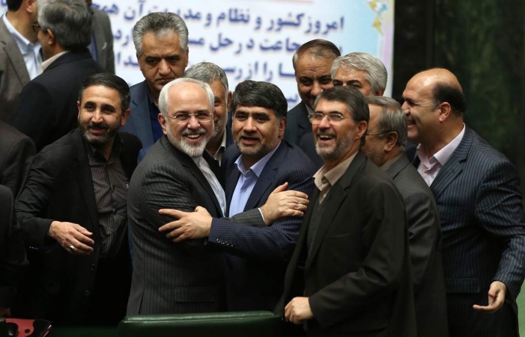 Iranian Foreign Minister Mohammad Javad Zarif second left who is also Iran's top nuclear negotiator is surrounded by a group of lawmakers in an open session of parliament in Tehran Iran Sunday Jan. 17 2016