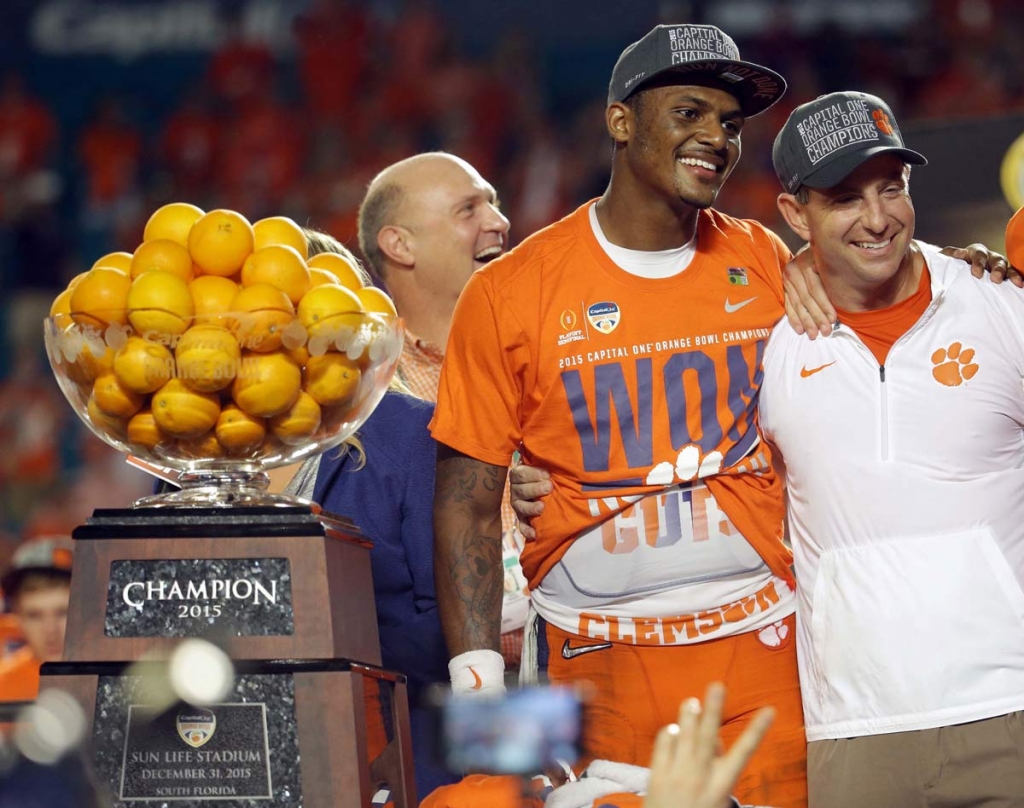 Clemson head coach Dabo Swinney poses with quarterback Deshaun Watson during Orange Bowl trophy presentation following the NCAA college football semifinal playoff game against Oklahoma Thursday Dec. 31 2015 in Miami Gardens Fla