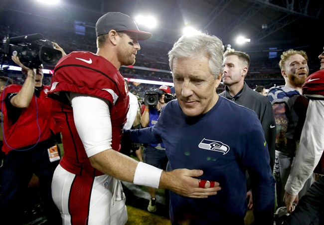 Arizona Cardinals quarterback Carson Palmer greets Seattle Seahawks head coach Pete Carroll after an NFL football game Sunday Jan. 3 2016 in Glendale Ariz. The Seahawks won 36-6