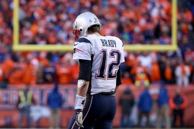 Tom Brady walks off the field after a failed two-point conversion in the Patriots’ 20-18 loss Sunday to the Broncos