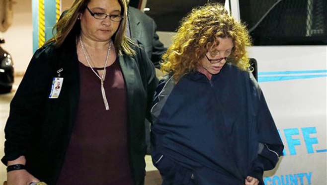 Tonya Couch second from right is escorted into Tarrant County Jail in Fort Worth Texas Thursday Jan. 7 2016. Couch mother of a fugitive teenager known for using an'affluenza defense in a deadly drunken-driving case waived extradition and was sen