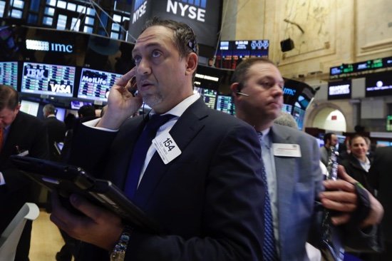 Trader Fady Tanois left works on the floor of the New York Stock Exchange