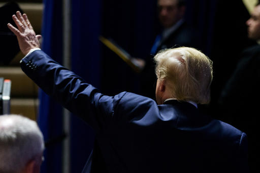 Republican presidential candidate Donald Trump waves to members of the audience as he departs after speaking at a rally at Muscatine High School in Muscatine Iowa Jan. 24 2016