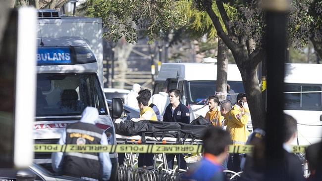 Turkish paramedics carry a dead body after a terrorist explosion killed at least 10 people and wounded 15 others near Istanbul's tourist hub of Sultanahmet