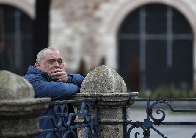 A man watches the site of Tuesday's explosion in the historic Sultanahmet district in Istanbul Wednesday Jan. 13 2016. A suicide bomber detonated a bomb in the heart of Istanbul's historic district on Tuesday morning killing 10 foreigners- most of