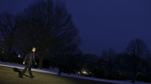 U.S. President Barack Obama walks down the colonnade from the Oval Office at The White House in Washington