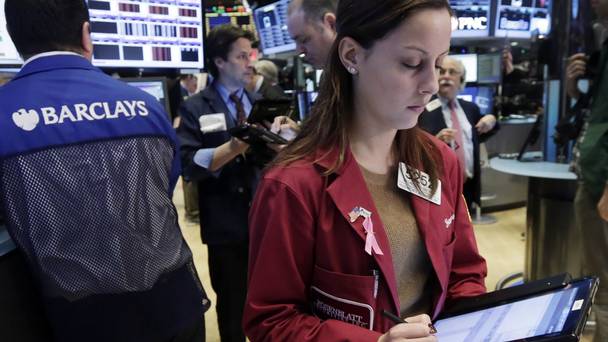 Trader Francesca Grosso works on the floor of the New York Stock Exchange as the market made small gains led by utilities and telecommunications stocks